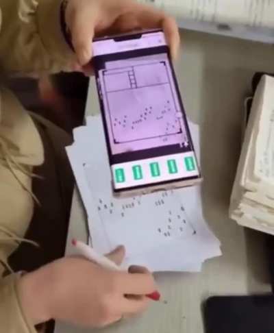 Teacher in China using a state issued Visual AI system to grade student exams.