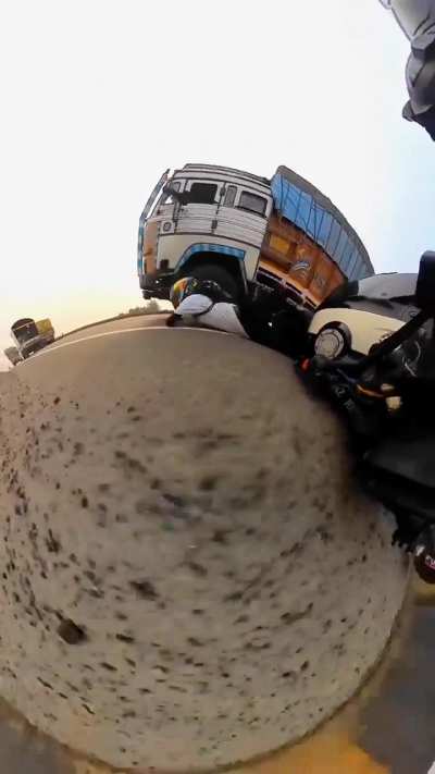 WCGW if you stand while riding a motorbike right next to a big goods truck?