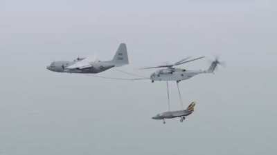 A US Marine CH-53K King Stallion carrying a Navy F-35 being refuelled by a KC-130T