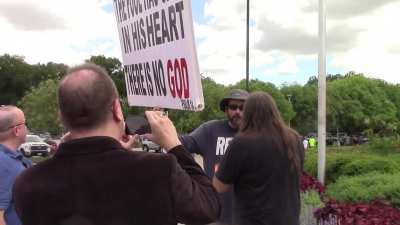An atheist and a Christian getting into an argument outside the meeting place for an atheist organization in Fort Worth, Texas