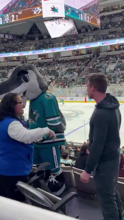 Hockey fan gets into it with Mascot after he allegedly shoves him out of his chair.