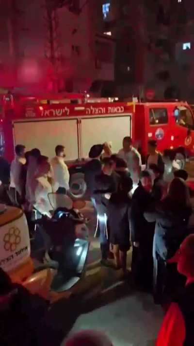 Smoke rose over Bnei Brak in central Israel as sirens blared and residents fled to the streets following a reported Iranian missile strike.