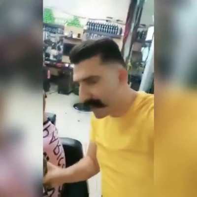 A Syrian Barber comforts a girl after cutting her hair cz she had some skin disease and she thought that she became ugly, 