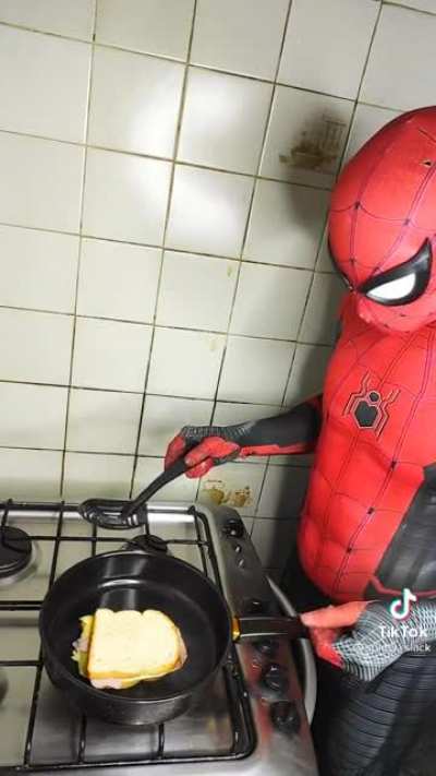 Spider man learns how to flip a grilled cheese