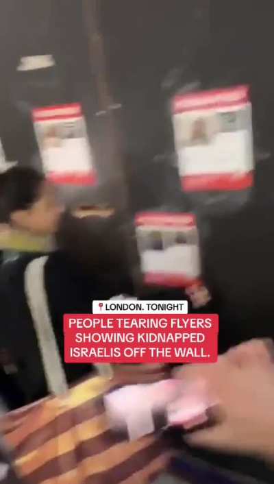 People tearing of flyers showing kidnapped Israelis off the wall