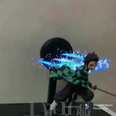 This Demon Slayer figure has an animating background