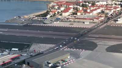 High way running right through the tarmac of an airport.