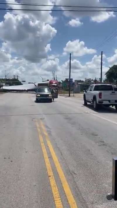 Train cuts through windmill blade at crossing