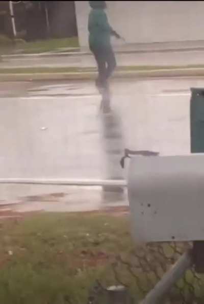 Woman pointing gun at random cars on the road