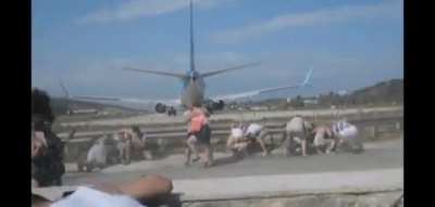 DBS standing behind an airplane that is taking off!