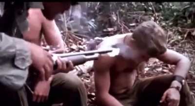 American soldiers in Vietnam smoking Marijuana out of the barrel of a Shotgun, 1970.