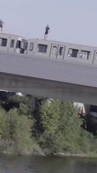 Hold Our Red Bulls as we leap off the moving train into the river.