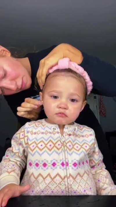 Mom applies brow gel and ice to baby's head to fix her 