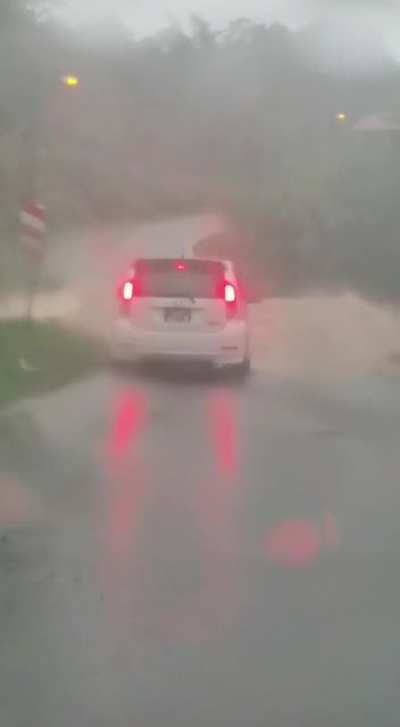 Small car thinks he could go through flood water .