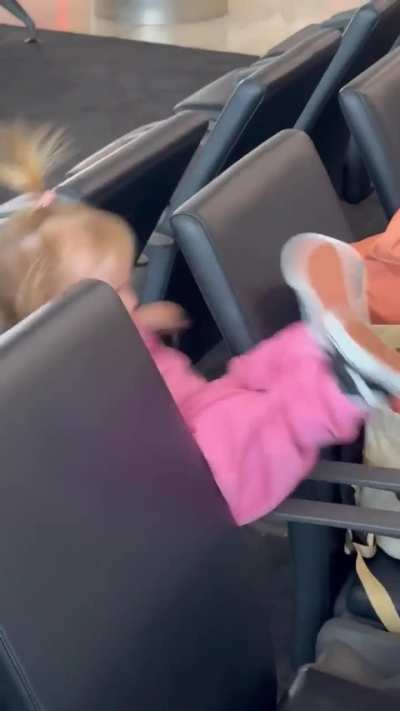 Playing on the airport seats