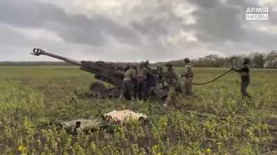 An M777 and ammunition is readied to fire in a new firing position, fires, then is towed away by an interestingly marked FMTV truck