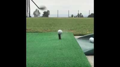 Playing golf.