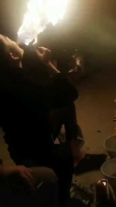 Trying to impress friends with a fire trick but failing miserably.

