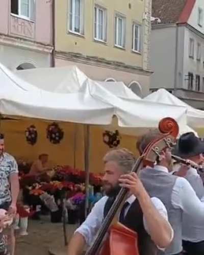 Music band in Poland playing on a bike riding through town