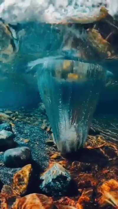 Majestic rock dropping into crystal clear water