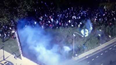 Philadelphia police pin protesters against wall and shoot tear gas.