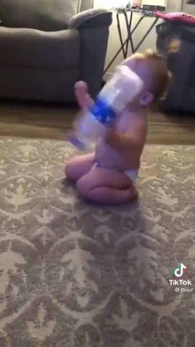 Baby flips a bottle...