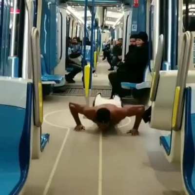 Guy thinks subway train is his personal gym