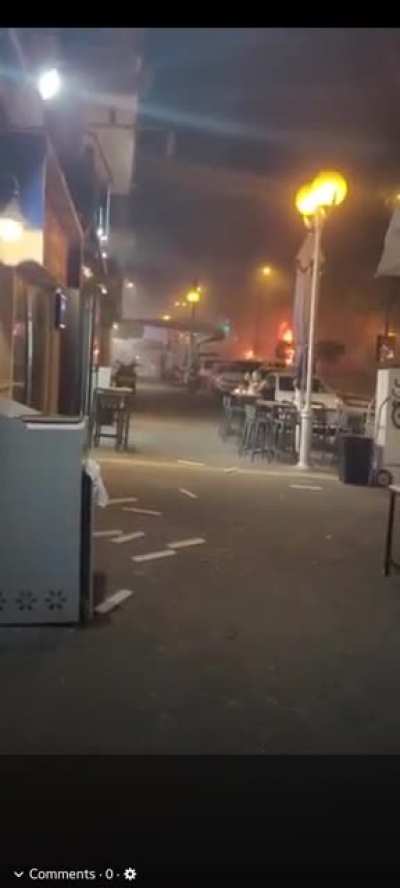 Man Is Unfazed By Missile Strike. Continues To Eat At Table On Sidewalk. 