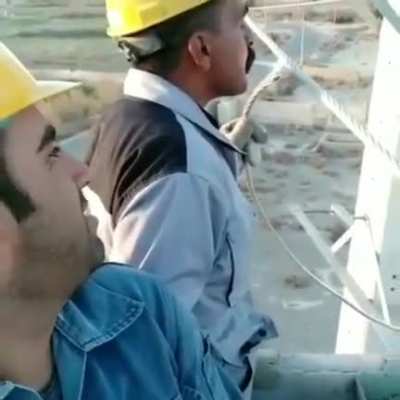 Electrician fires a cigarette from a high-voltage line