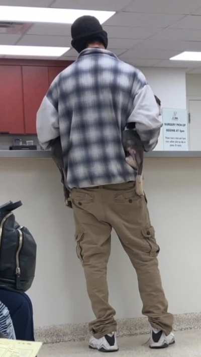 Man bringing two wiggly puppers into the vets