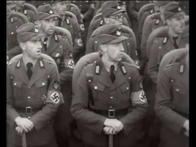 Footage from the propaganda film “Triumph of the Will”, 1935. The Reich Labor Service has an outdoor rally at Nuremberg, presenting in front of Hitler and other Nazi officials.
