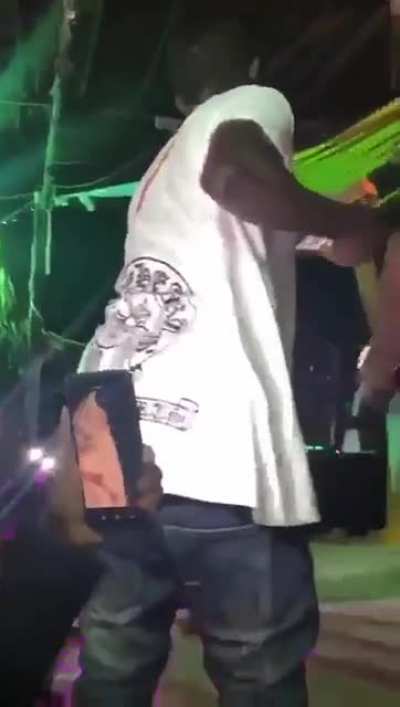 Ugandan singer appears to kick out at a fan who tried to touch her private parts during a performance