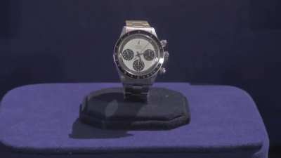 Vietnam veteran being told how much his Rolex watch is worth