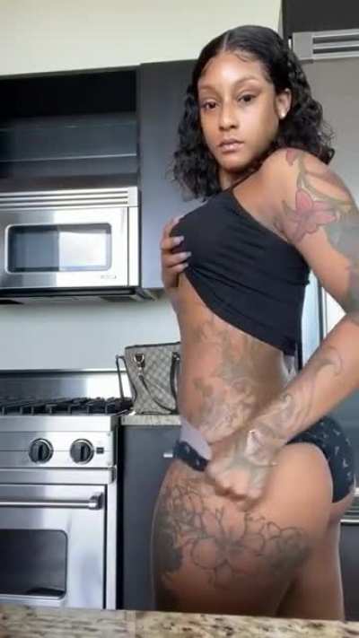 Showing her tattoos