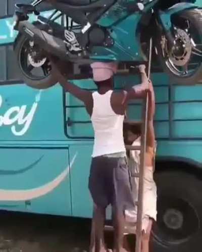 Carrying 313 lbs bike on his head like it's his cup of tea..