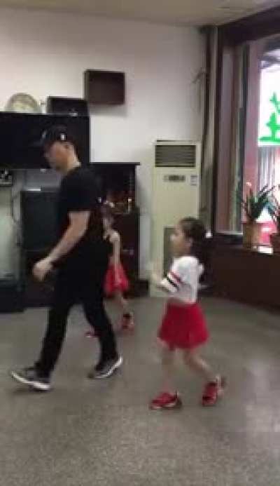 Perfectly synchronized dance by dad and daughters