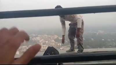 Hanging out up high while dressed like he just got off work on casual Friday.