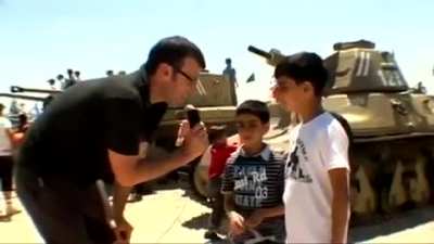 Reporter: what do you imagine when you ride the tank?... Kid 1: killing people... kid 2: they are from Gaza... kid 3: killing Arabs, that's makes me happy!.... kid 4: I picture dead Arab.... reporter: do you want to kill them all?... Kid: yes.. Reporter: 