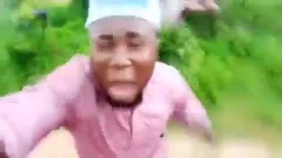 African guy running from tribe member