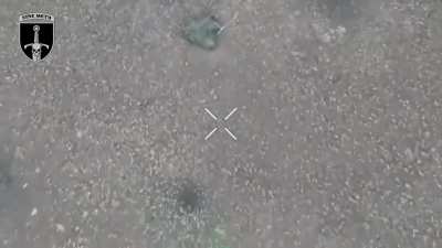 Two Russian soldiers trying to cross a field under a camouflaged net and being attacked by UAV-dropped munitions.