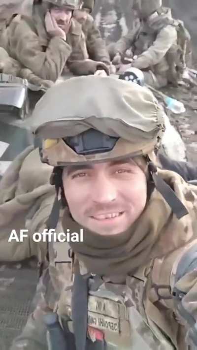 Ukrainian infantry raise a smile as they ride their BMP-1 IFV across the open steppe.