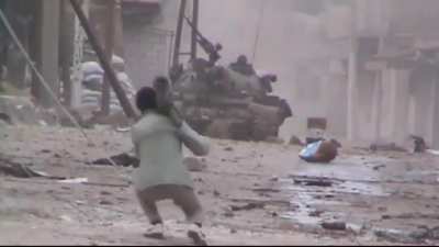 FSA fighter pops out with an M-79 OSA and attacks a Syrian Army tank - Daraa al-Balad - 2/18/2013