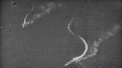 US Navy aircraft strafing Japanese vessels gets its tail blown off by flak off Manilla in 1945