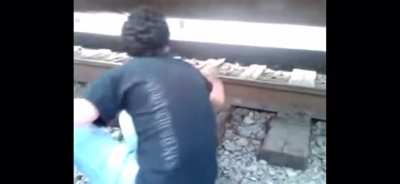 Idiot teenagers put coins underneath moving train