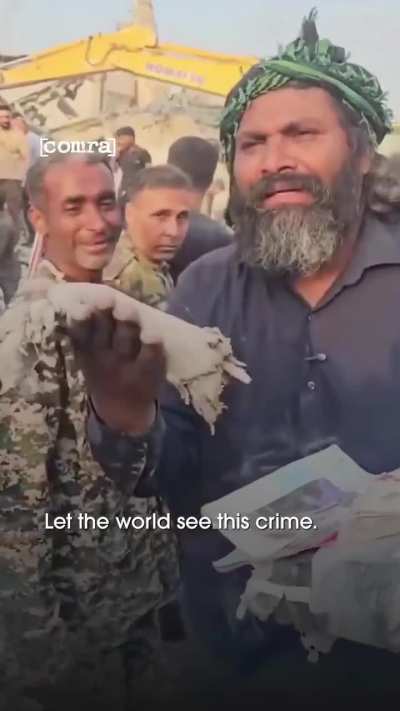 An Iranian breaks down on camera, holding the remains of a girl after US-Israeli strikes on a southern elementary school: