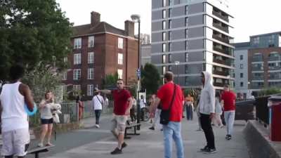 Man swipes at woman's dog and is confronted by bystanders. Defends himself with a bottle. London
