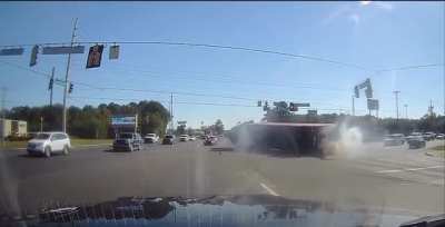 Truck driver changes lanes and flips over onto passenger car.