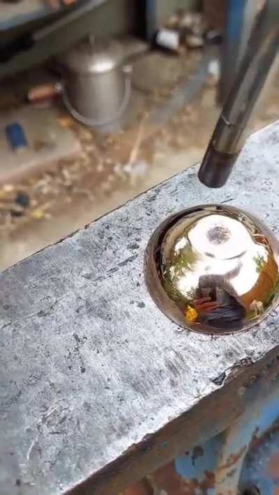 Using fire to reveal the pattern in this mokume gane (layered copper and nickel) cup.