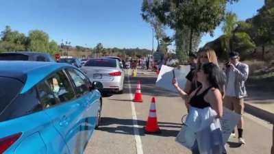 Antivax covidiots harassing people waiting in line at a vaccination center