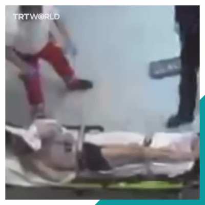 A German paramedic is seen punching a Syrian refugee on a stretcher in front of police who seem to turn a blind eye to the violent attack